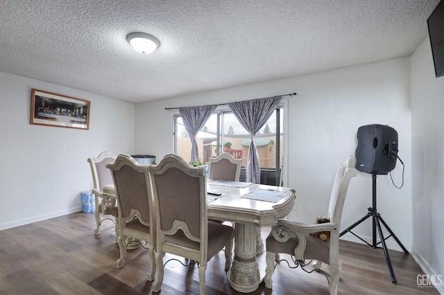 dining room with hardwood / wood-style floors and a textured ceiling