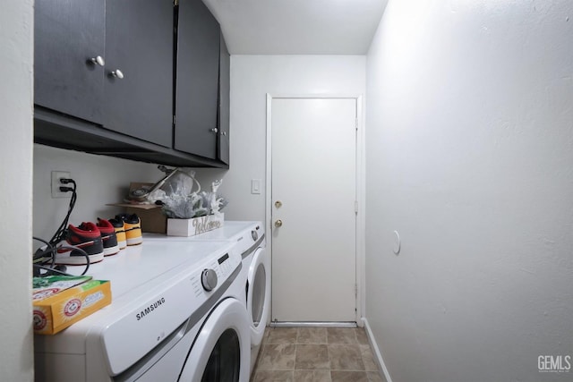 laundry room with washer and dryer and cabinets