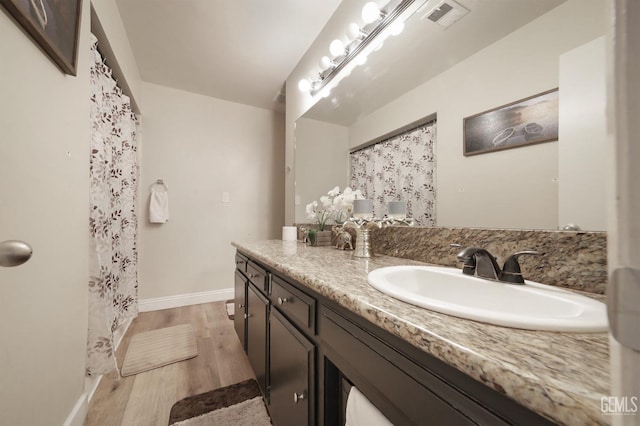 bathroom with vanity and wood-type flooring