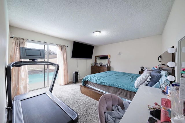 bedroom with carpet flooring and a textured ceiling