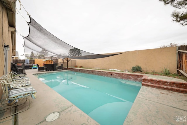 view of pool featuring a patio and a mountain view