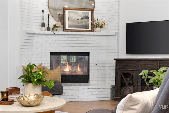 6707 Park W Cir, Bakersfield, CA 93308 - living area featuring wood finished floors and a brick fireplace