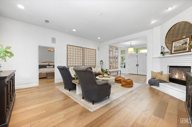 6707 Park W Cir, Bakersfield, CA 93308 - living room featuring light wood-style flooring, a fireplace, and recessed lighting