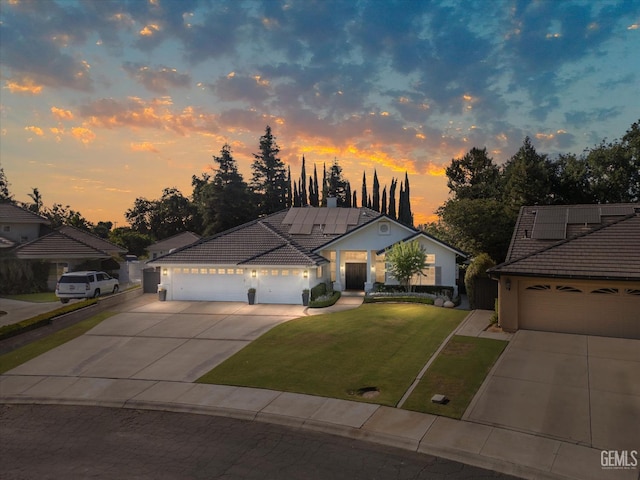 6707 Park W Cir, Bakersfield, CA 93308 - view of front of property with concrete driveway, a tile roof, a yard, and a garage