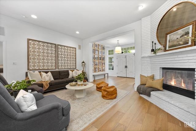 6707 Park W Cir, Bakersfield, CA 93308 - living room with wood finished floors, a brick fireplace, and recessed lighting