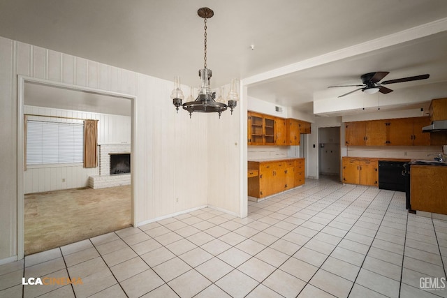 kitchen with light colored carpet, exhaust hood, ceiling fan with notable chandelier, dishwasher, and brown cabinets