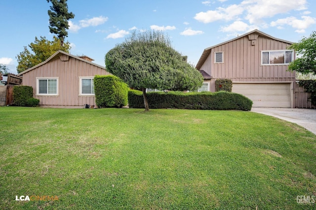 view of front of house with a front yard, board and batten siding, concrete driveway, and an attached garage