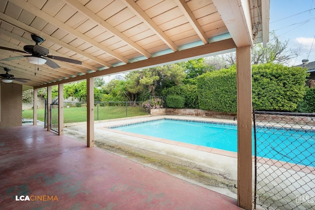 view of swimming pool featuring a fenced backyard, a fenced in pool, a patio area, a ceiling fan, and a lawn