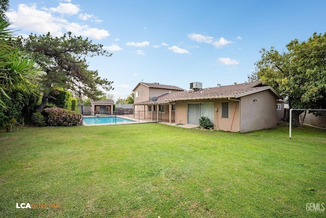exterior space with stucco siding, a fenced in pool, a lawn, and a fenced backyard