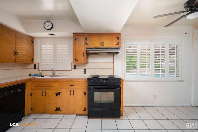 kitchen with backsplash, a sink, under cabinet range hood, black appliances, and ceiling fan
