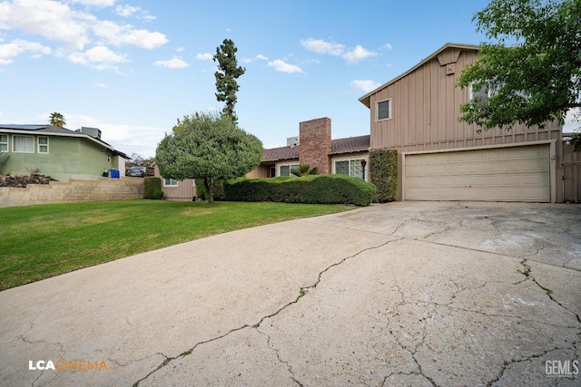 view of front facade featuring board and batten siding, concrete driveway, a garage, and a front lawn