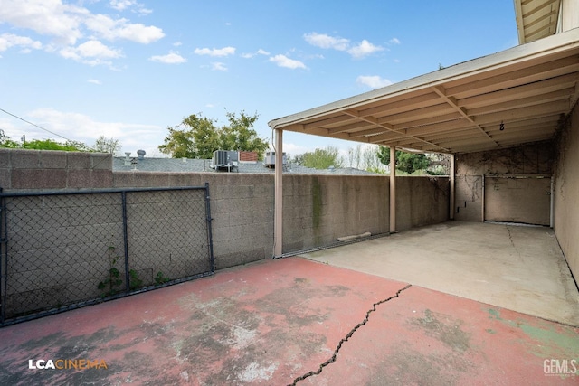 view of patio with an attached carport, cooling unit, and fence