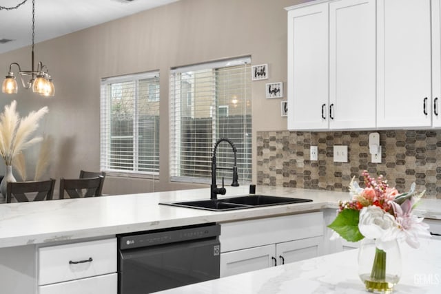 kitchen with tasteful backsplash, dishwashing machine, light stone countertops, white cabinetry, and a sink