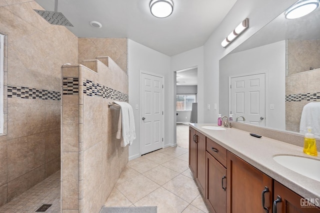 bathroom featuring tile patterned floors, a sink, and a walk in shower