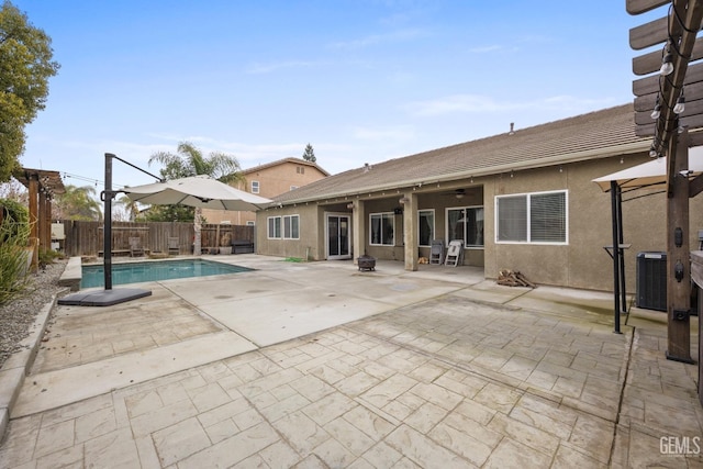 view of swimming pool featuring central AC, a patio area, a fenced backyard, and a fenced in pool