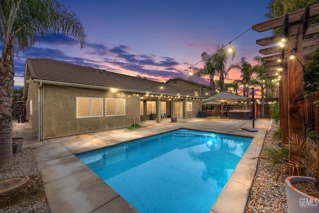 view of swimming pool featuring a patio area, fence, and a fenced in pool