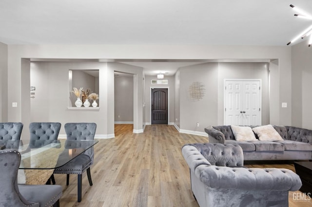 living area with light wood finished floors and baseboards