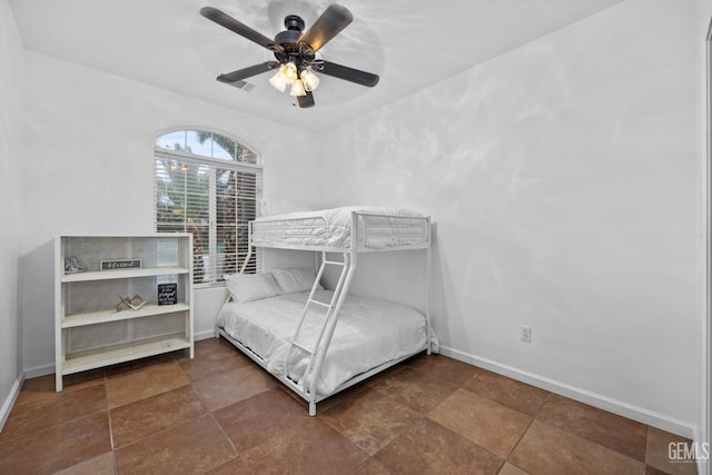 bedroom with ceiling fan and baseboards