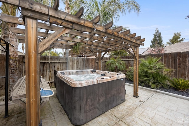 view of patio featuring a pergola, a fenced backyard, and a hot tub