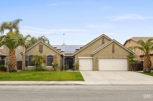 ranch-style home with an attached garage, concrete driveway, roof mounted solar panels, a front lawn, and stucco siding