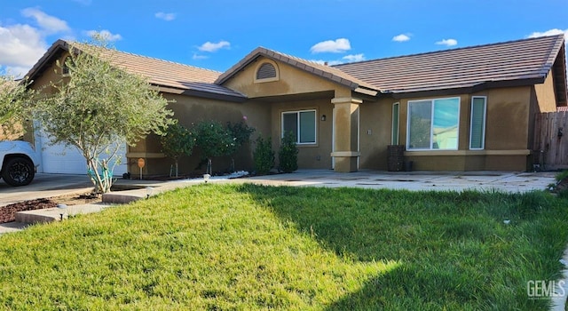 view of front of property with a front yard and a garage