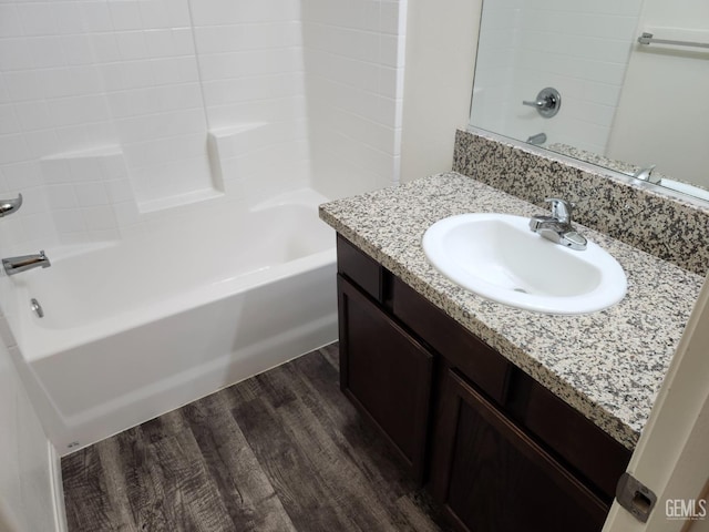 bathroom with vanity, wood-type flooring, and tub / shower combination