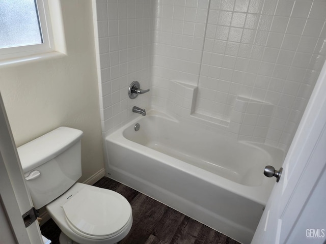 bathroom with bathtub / shower combination, hardwood / wood-style floors, and toilet