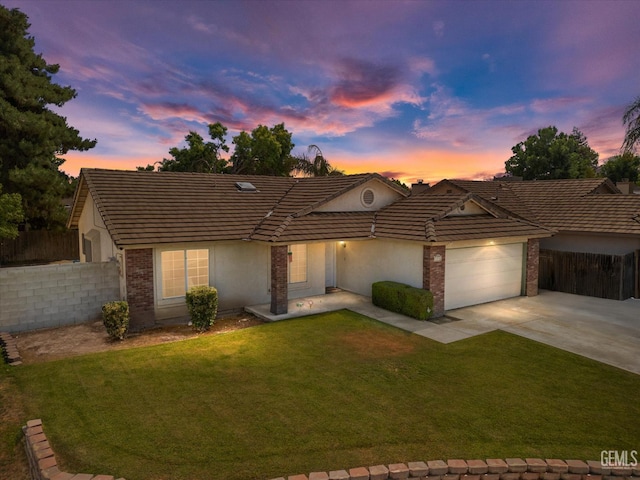 4715 Peacock Ct, Bakersfield, CA 93313 - single story home with concrete driveway, stucco siding, a tiled roof, a garage, and brick siding