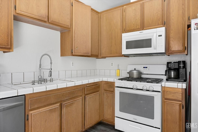 4715 Peacock Ct, Bakersfield, CA 93313 - kitchen with white appliances, a sink, and dark wood-style floors