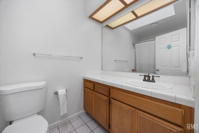 4715 Peacock Ct, Bakersfield, CA 93313 - bathroom featuring vanity, toilet, tile patterned floors, and baseboards