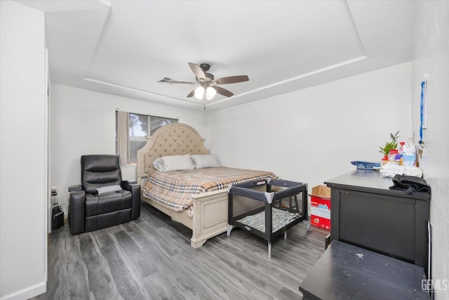 4715 Peacock Ct, Bakersfield, CA 93313 - bedroom featuring a tray ceiling, wood finished floors, ceiling fan, and baseboards