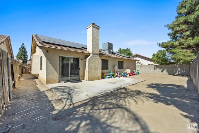 4715 Peacock Ct, Bakersfield, CA 93313 - rear view of property with stucco siding, a fenced backyard, a patio, and solar panels