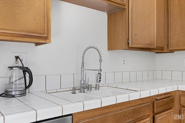 4715 Peacock Ct, Bakersfield, CA 93313 - kitchen featuring a sink, light countertops, and brown cabinets