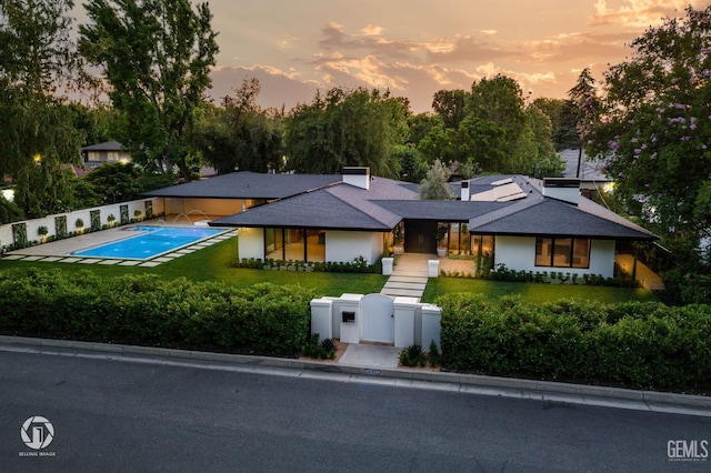 2221 Myrtle St, Bakersfield, CA 93301 - prairie-style house featuring a gate, a fenced in pool, a lawn, and a fenced front yard