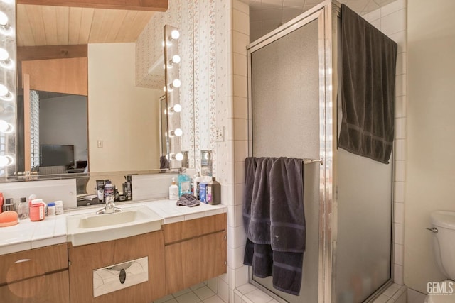 2221 Myrtle St, Bakersfield, CA 93301 - full bathroom featuring tile patterned floors, toilet, a stall shower, and vanity