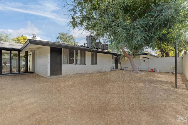 2221 Myrtle St, Bakersfield, CA 93301 - exterior space with cooling unit, concrete block siding, and fence