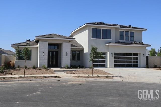 12610 Espalier Ct, Bakersfield, CA 93311 - prairie-style home with an attached garage, concrete driveway, and stucco siding