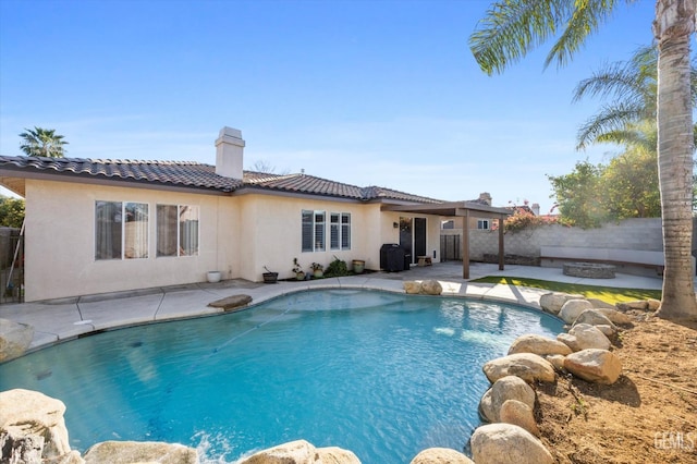 view of swimming pool with an outdoor fire pit, fence, a fenced in pool, and a patio