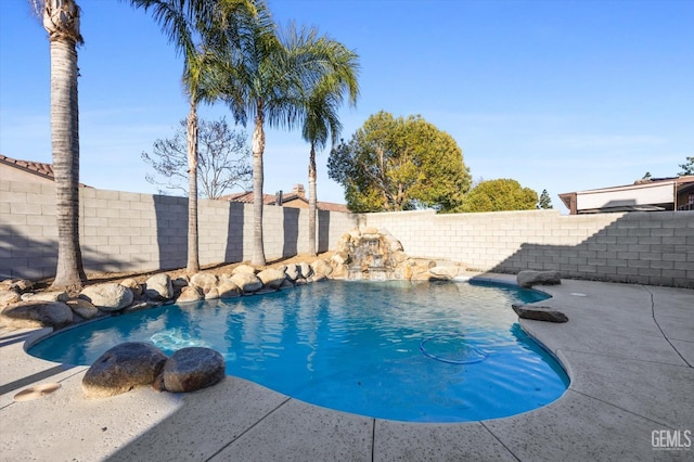 view of swimming pool featuring a fenced in pool, a fenced backyard, and a patio