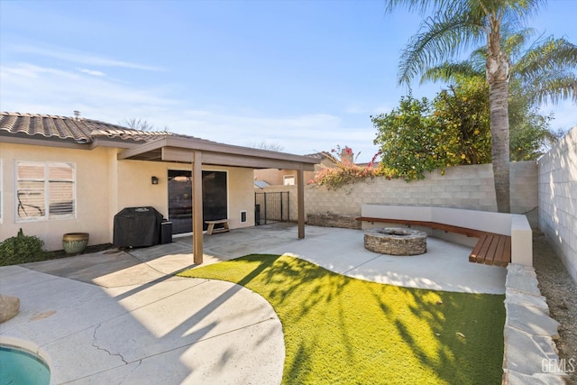 exterior space with a tile roof, stucco siding, an outdoor fire pit, a patio area, and a fenced backyard