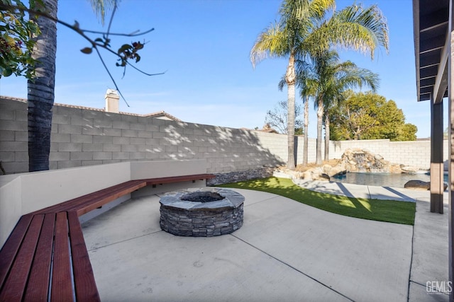 view of patio / terrace with a fenced backyard and a fire pit