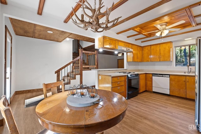 kitchen featuring gas stove, ceiling fan, sink, beamed ceiling, and white dishwasher