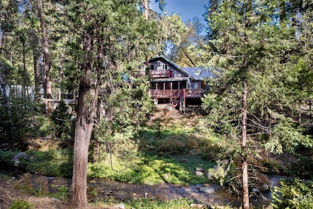 back of house with a deck with water view