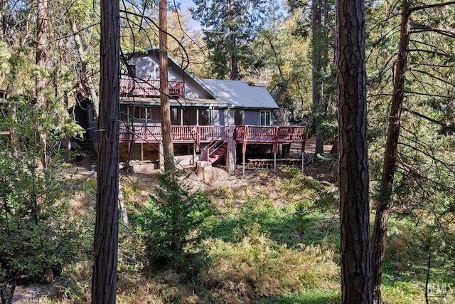 rear view of property with a wooden deck