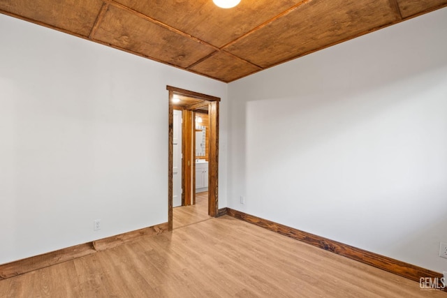 unfurnished room featuring light hardwood / wood-style flooring and wood ceiling