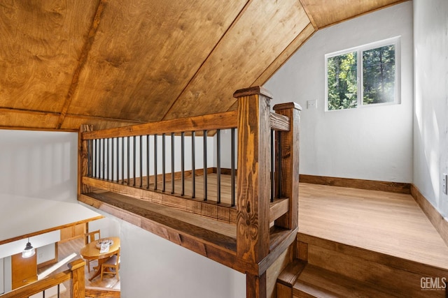 stairway featuring wood ceiling and vaulted ceiling