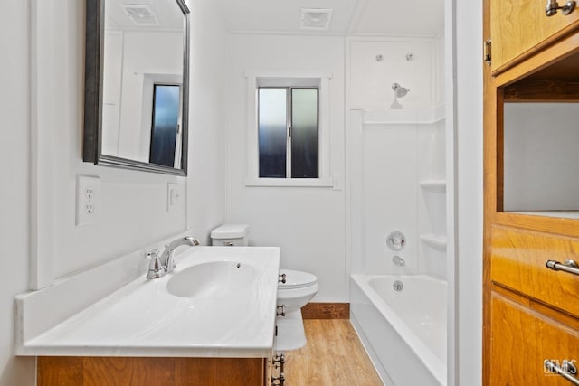 full bathroom with bathtub / shower combination, vanity, hardwood / wood-style flooring, and toilet