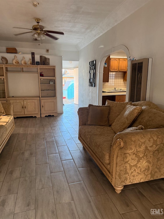 1107 Monterey St, Bakersfield, CA 93305 - living room featuring ceiling fan, wood finished floors, and arched walkways