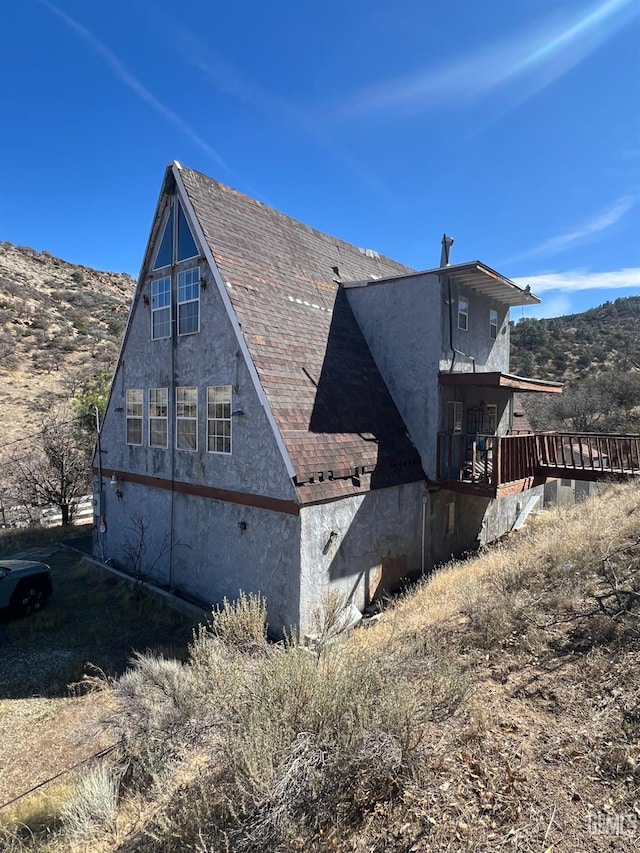 view of home's exterior featuring a mountain view and stucco siding