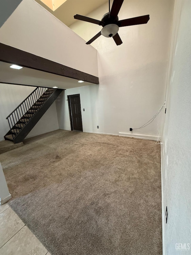3600 O St Unit 22, Bakersfield, CA 93301 - unfurnished living room featuring carpet flooring, a high ceiling, stairs, and ceiling fan